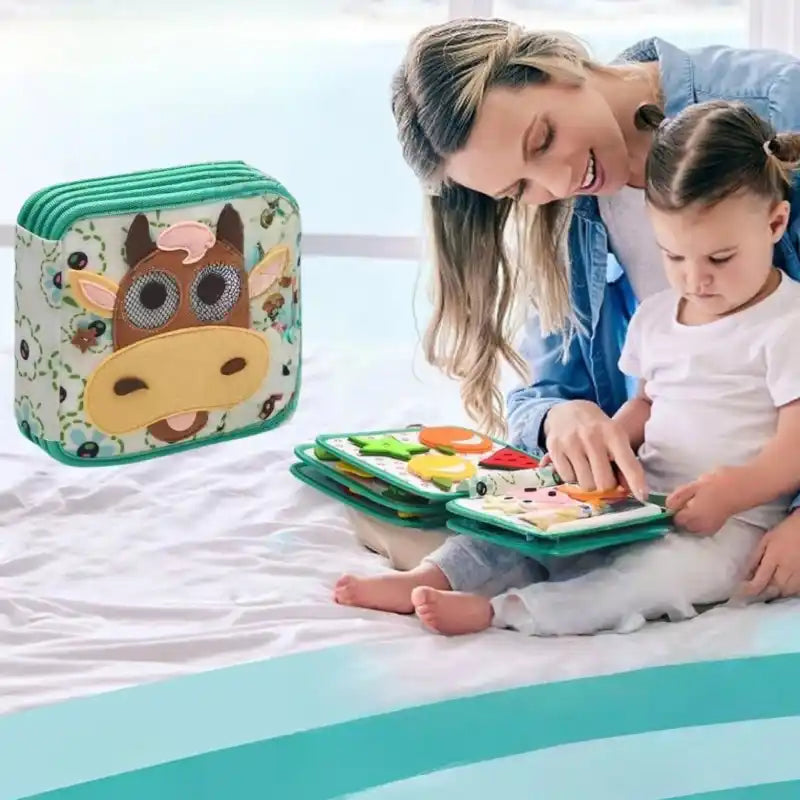 Busy Board Livre en Tissu Vache Montessori